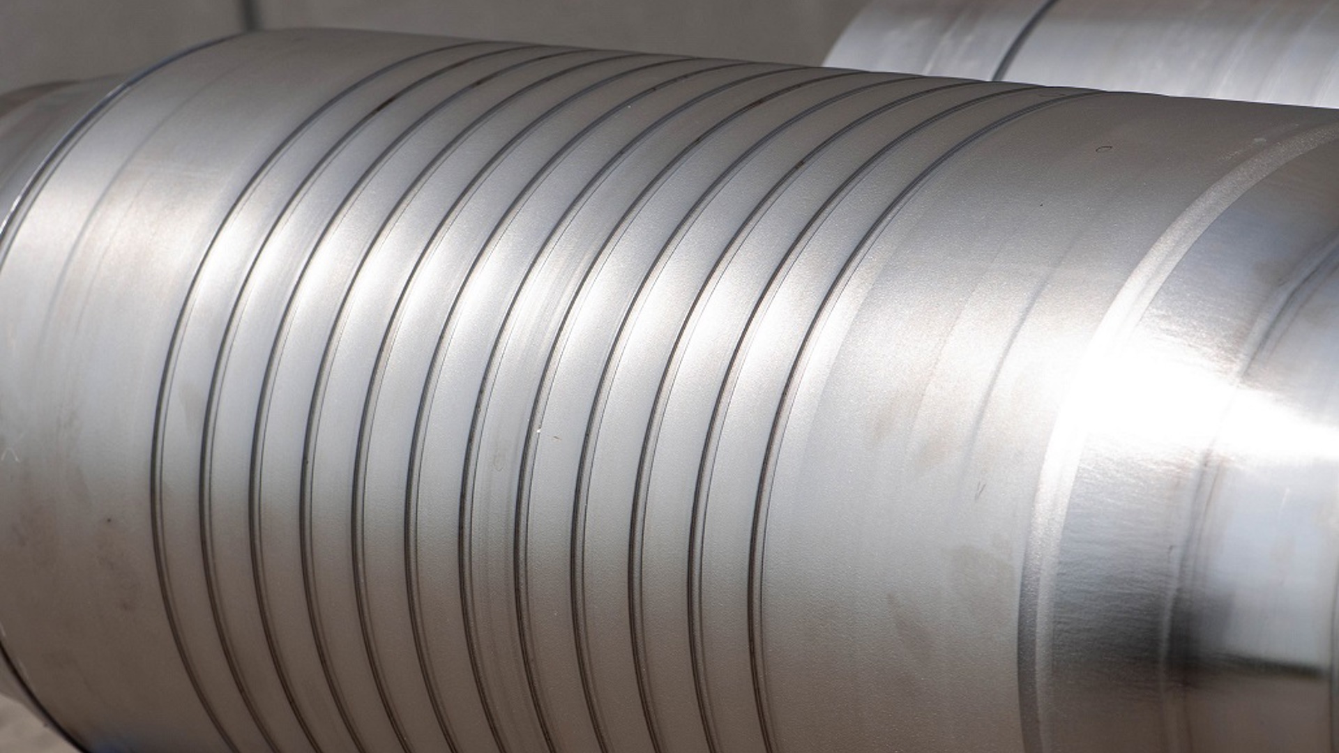 A close-up shot of a cylindrical metal WAB with parallel grooves running along its length.